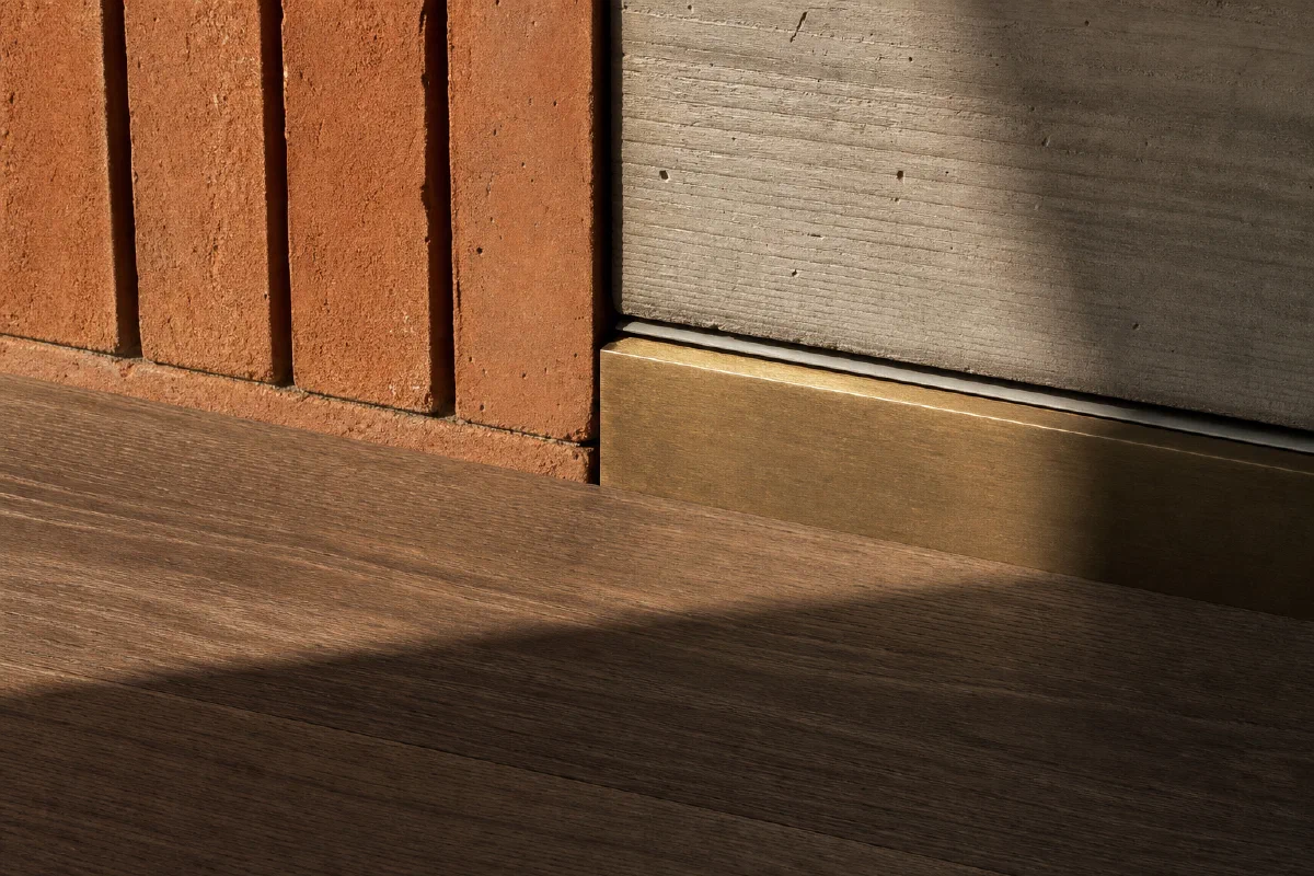 Conceptual detail of brick, concrete, brass and timber